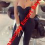Promotional mirror selfie of a woman in a strapless black jumpsuit at a salon, with a red diagonal escort banner across the image.