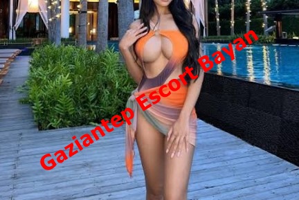 Woman in an orange-beige swimsuit posing by a pool at a resort; red diagonal text reads 'Gaziantep Escort Bayan'