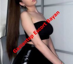 Advertisement photo of a woman with long dark hair wearing a black tube top and shiny black skirt; red diagonal text reads 'Gaziantep Escort Bayan'.